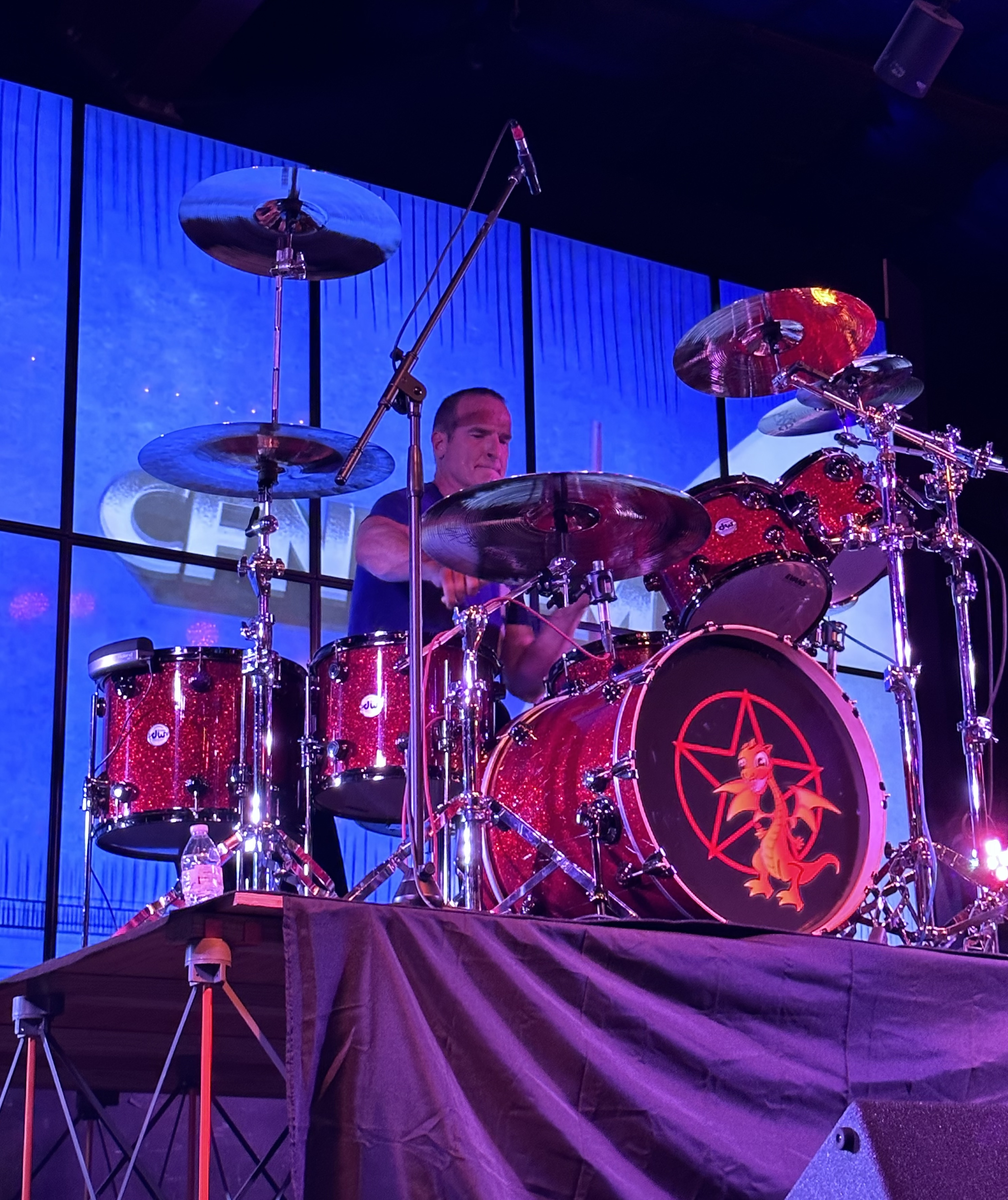 Matt Beeson playing drums, up perspective, on riser